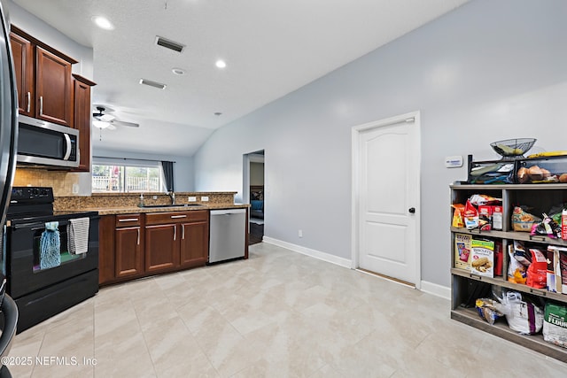 kitchen with a peninsula, visible vents, appliances with stainless steel finishes, and a sink