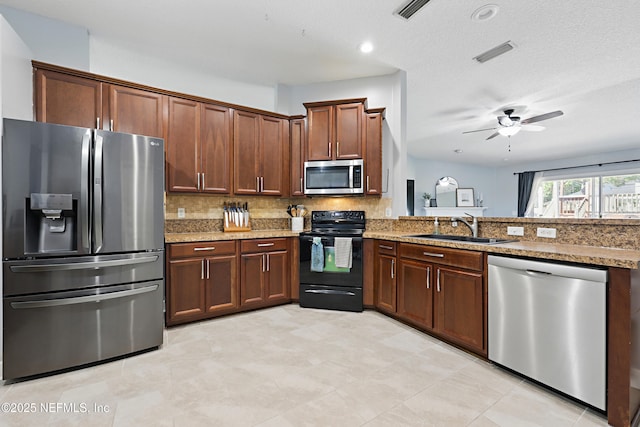 kitchen featuring a sink, stainless steel appliances, backsplash, and visible vents