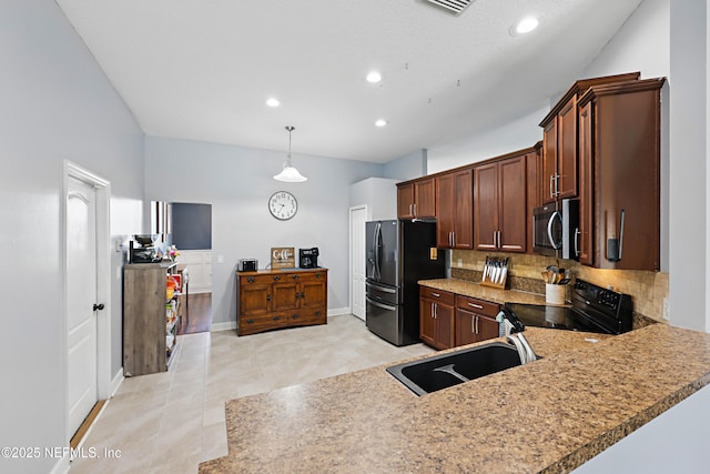 kitchen featuring a sink, black range with electric stovetop, stainless steel microwave, fridge with ice dispenser, and backsplash