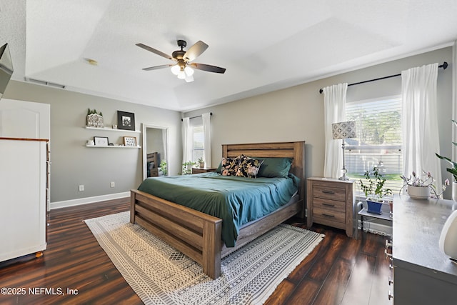 bedroom with visible vents, multiple windows, and dark wood-style flooring