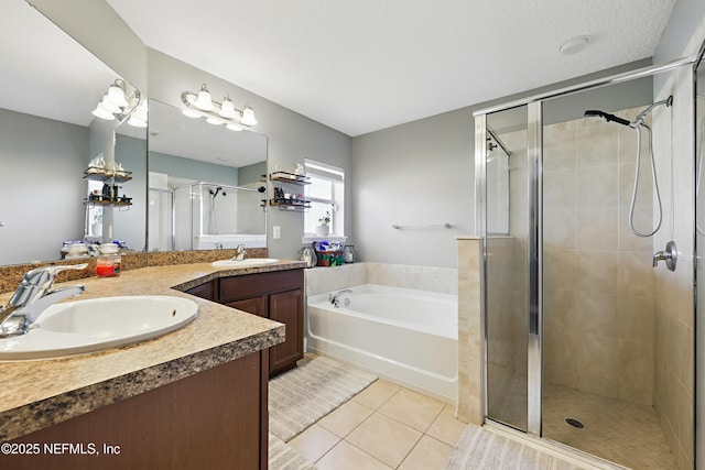 full bathroom featuring tile patterned floors, double vanity, a stall shower, and a sink