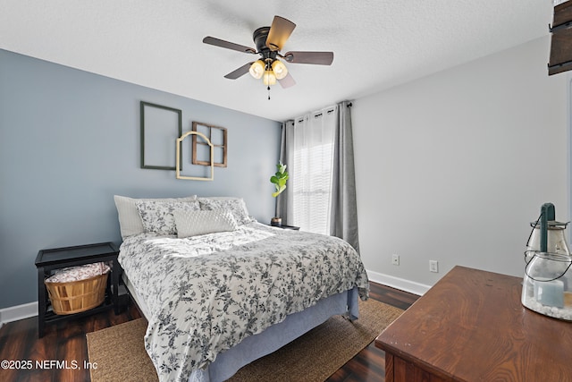 bedroom with a textured ceiling, a ceiling fan, baseboards, and dark wood-style flooring