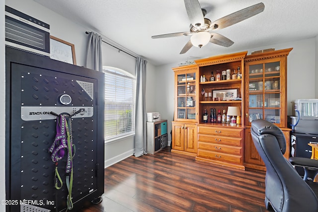 office space with dark wood-type flooring, a ceiling fan, and a textured ceiling