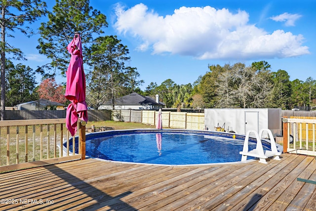 view of pool with a fenced in pool, a deck, and a fenced backyard