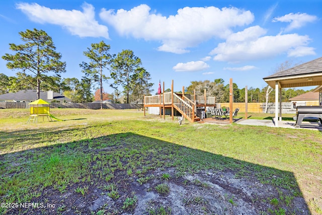 view of yard featuring a patio area, stairway, a fenced backyard, and a wooden deck