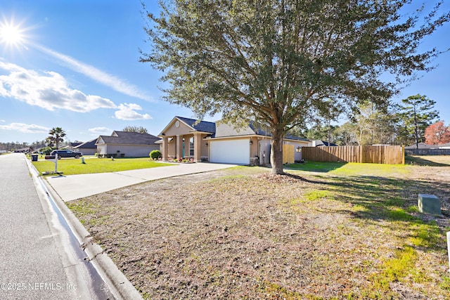 single story home featuring stucco siding, driveway, fence, a front yard, and an attached garage