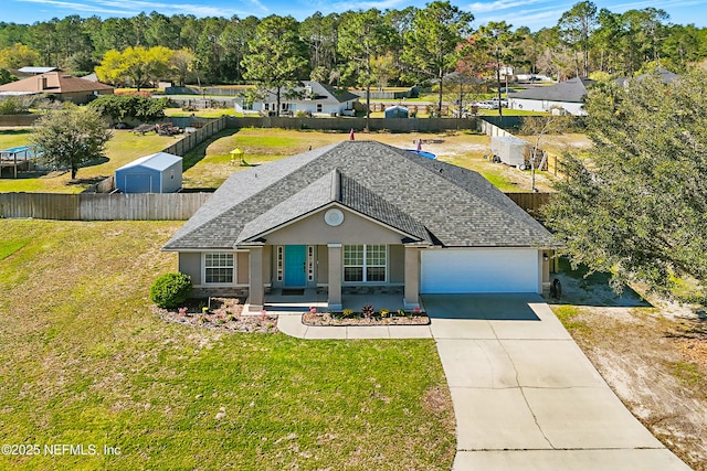 ranch-style house with an attached garage, fence, a front yard, stucco siding, and driveway