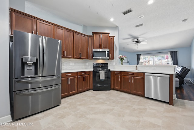 30302 Trophy Trl, Bryceville, FL 32009 - kitchen featuring stainless steel appliances, light countertops, visible vents, a sink, and a peninsula