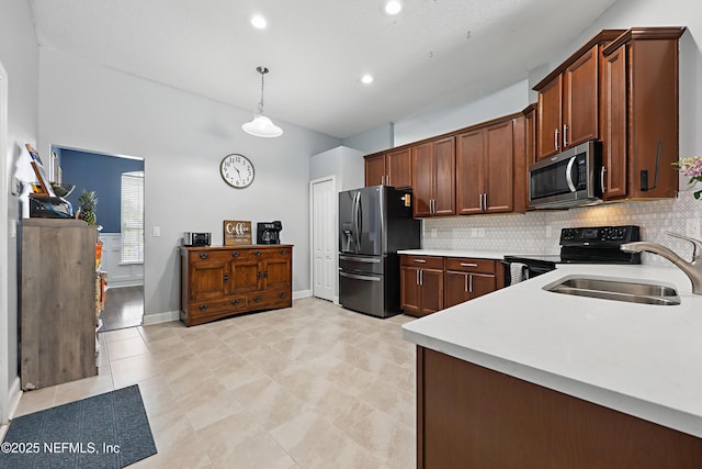 30302 Trophy Trl, Bryceville, FL 32009 - kitchen featuring a sink, decorative backsplash, pendant lighting, light countertops, and appliances with stainless steel finishes