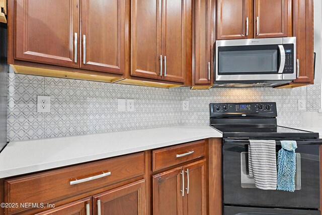 30302 Trophy Trl, Bryceville, FL 32009 - kitchen with brown cabinetry, decorative backsplash, light countertops, electric range, and stainless steel microwave
