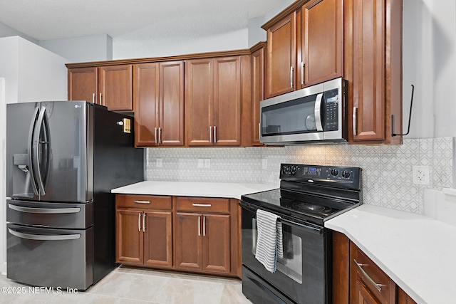 30302 Trophy Trl, Bryceville, FL 32009 - kitchen featuring stainless steel appliances, light countertops, backsplash, light tile patterned floors, and brown cabinetry