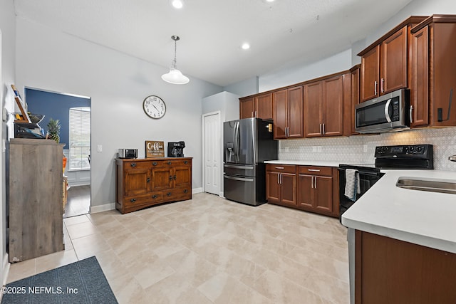 30302 Trophy Trl, Bryceville, FL 32009 - kitchen featuring stainless steel appliances, a sink, backsplash, light countertops, and decorative light fixtures