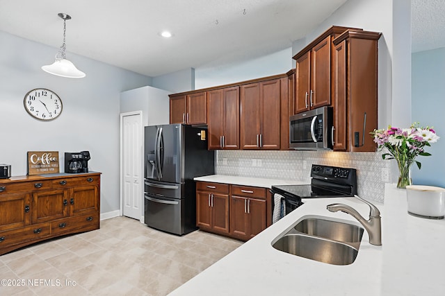 30302 Trophy Trl, Bryceville, FL 32009 - kitchen with light countertops, a sink, decorative light fixtures, decorative backsplash, and appliances with stainless steel finishes