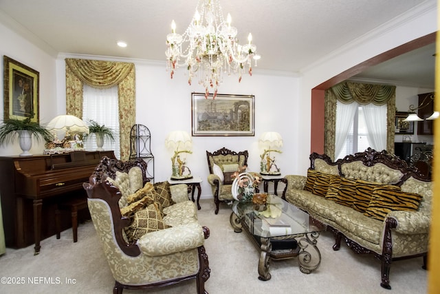 sitting room featuring a chandelier, ornamental molding, and carpet flooring