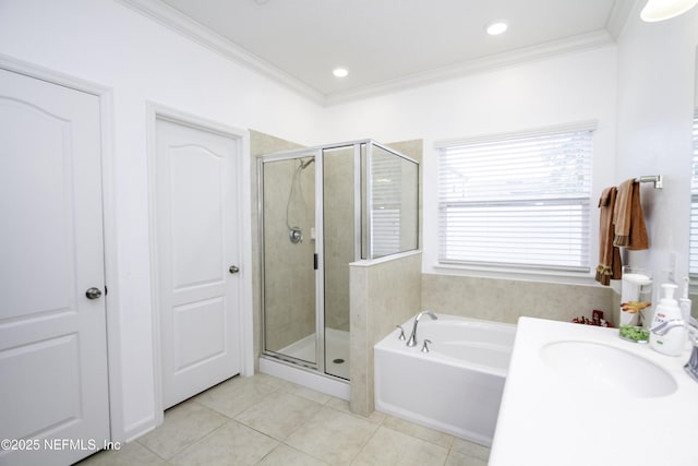 full bathroom with tile patterned flooring, a shower stall, crown molding, and a sink