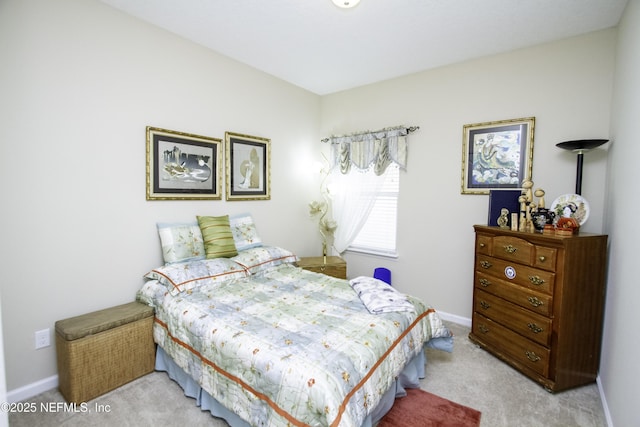 bedroom with light carpet and baseboards