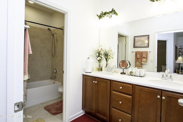 bathroom with tile patterned flooring, double vanity, toilet, and a sink