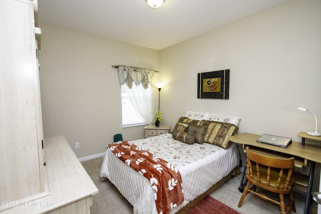 bedroom featuring baseboards and carpet