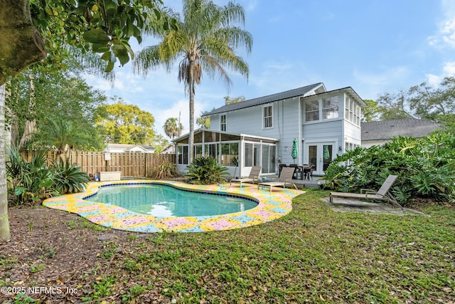 view of pool featuring a fenced in pool, french doors, fence, and a sunroom