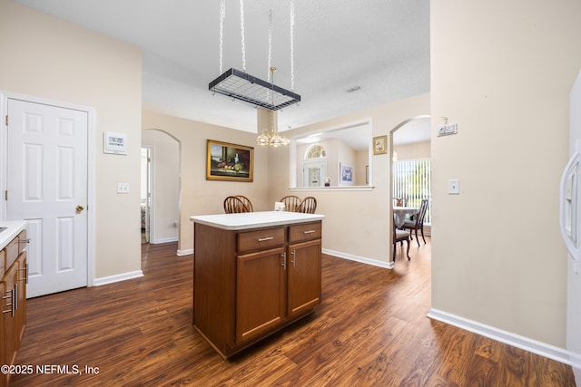 2017 Belhaven Dr, Orange Park, FL 32065 - kitchen featuring arched walkways, dark wood-type flooring, and light countertops