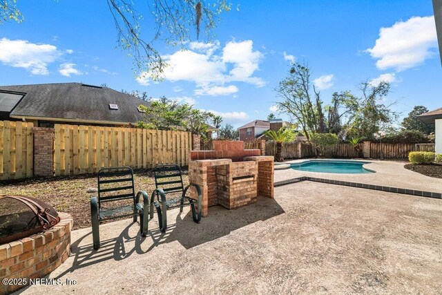 exterior space featuring a patio area, a fenced in pool, and a fenced backyard