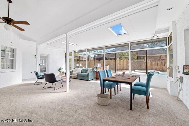 sunroom with lofted ceiling and a ceiling fan