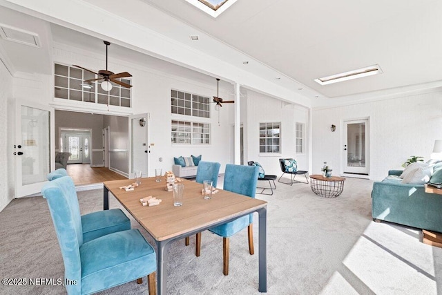 dining space with french doors, a ceiling fan, carpet, and ornamental molding