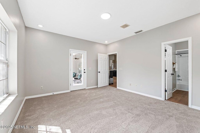 unfurnished bedroom featuring visible vents, baseboards, and carpet