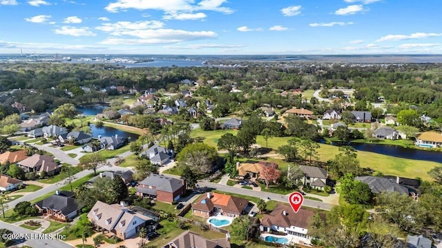 birds eye view of property featuring a water view and a residential view