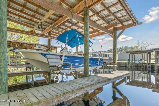 dock area with a water view and boat lift