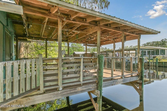 dock area with an exterior structure and a water view