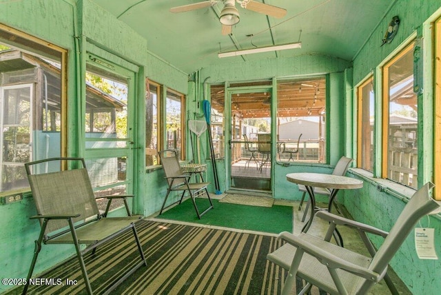 sunroom / solarium featuring a ceiling fan and vaulted ceiling