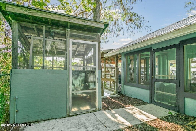 view of outdoor structure featuring a sunroom