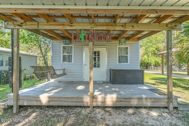 wooden terrace with a lawn