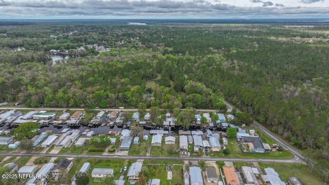 drone / aerial view featuring a wooded view