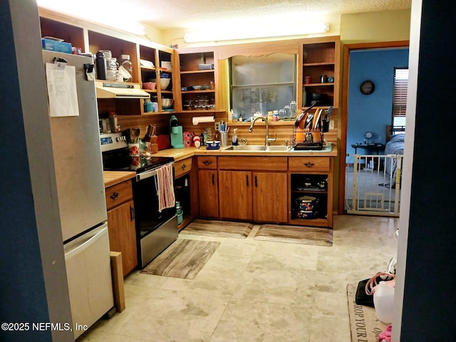 kitchen featuring a sink, open shelves, under cabinet range hood, appliances with stainless steel finishes, and light countertops