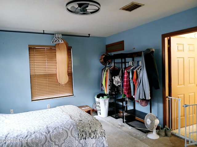 bedroom with visible vents and concrete flooring