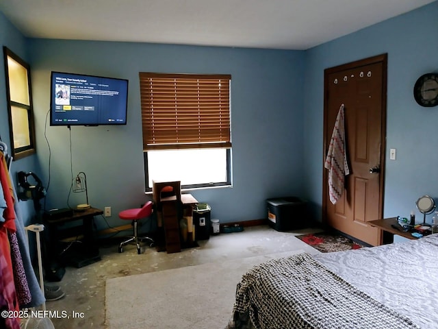 bedroom featuring unfinished concrete floors