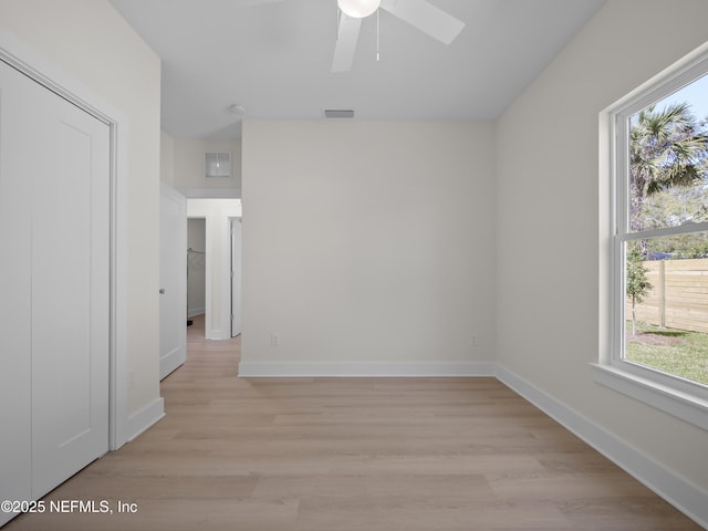 empty room featuring visible vents, baseboards, ceiling fan, and light wood finished floors