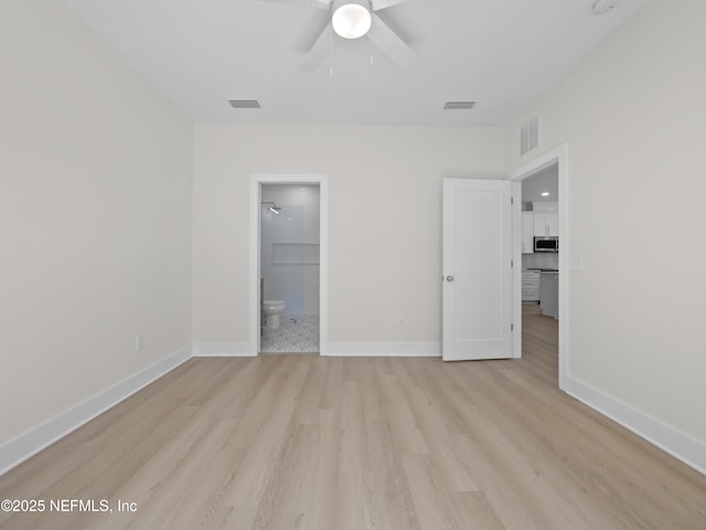 unfurnished bedroom with visible vents, light wood-type flooring, and baseboards