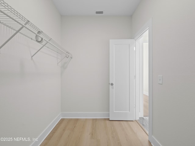 spacious closet featuring visible vents and light wood finished floors