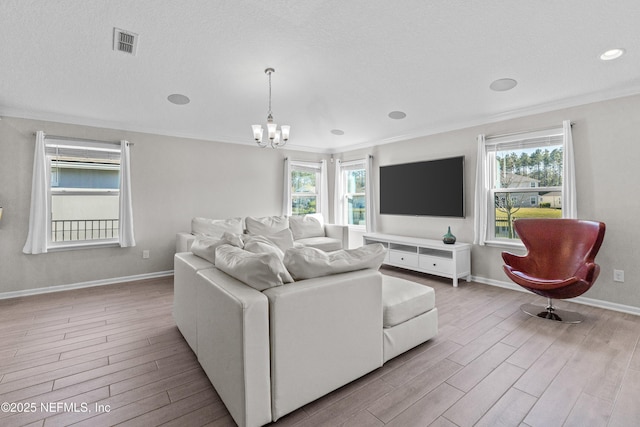 living area featuring visible vents, a healthy amount of sunlight, and light wood-style floors