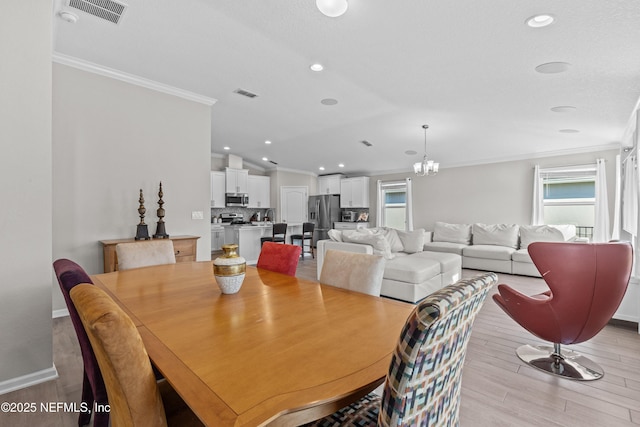 dining area featuring light wood-type flooring, recessed lighting, visible vents, and ornamental molding