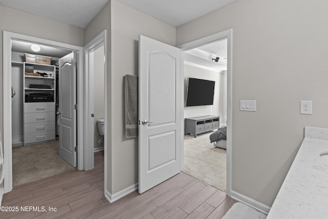 hallway with baseboards and light wood-type flooring