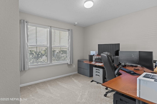 carpeted office space featuring baseboards and a textured ceiling