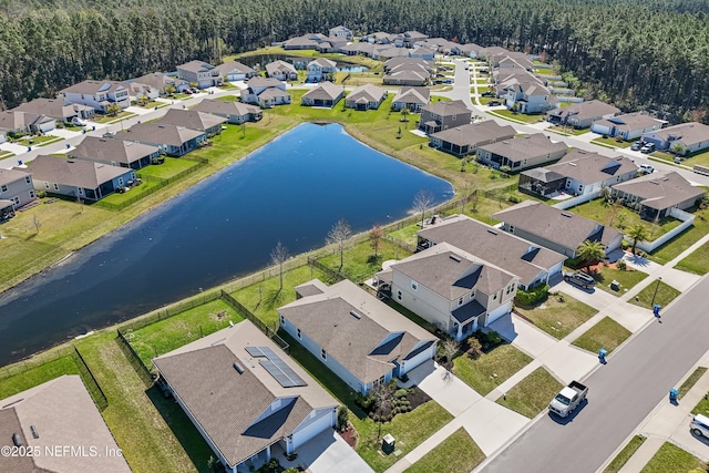 bird's eye view with a residential view and a water view