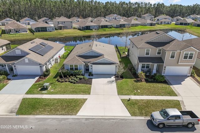 birds eye view of property with a residential view and a water view