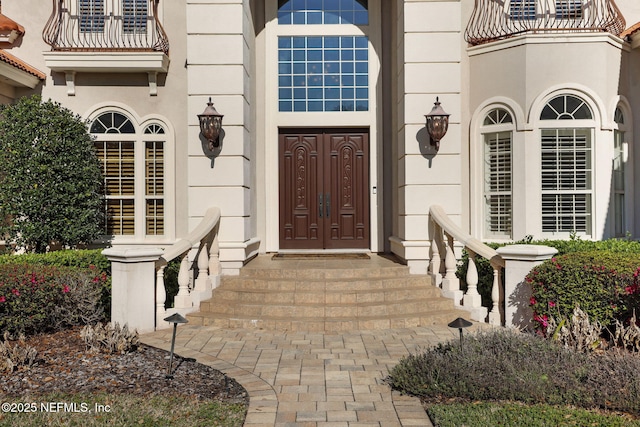 doorway to property featuring stucco siding