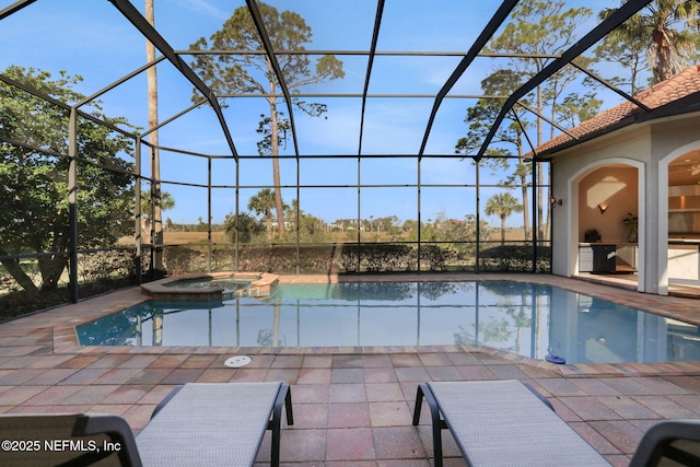 view of swimming pool with glass enclosure, a patio, and a pool with connected hot tub