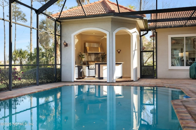 pool with glass enclosure and a patio